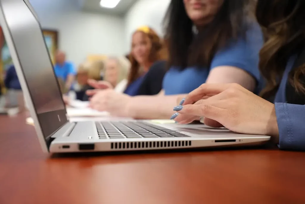 Woman working on a laptop in a conference room